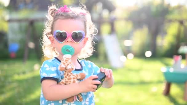 Stylish Little Girl Pacifier Heart Shaped Sunglasses Taking Photos Action — Stock Video