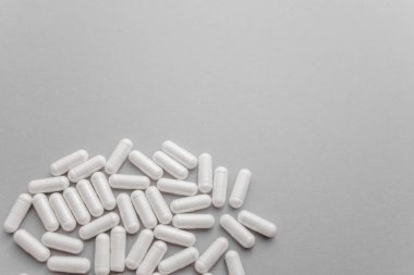 Scattered  white oval pills for health. Concept of healthy lifestyle, vitamins taking. 