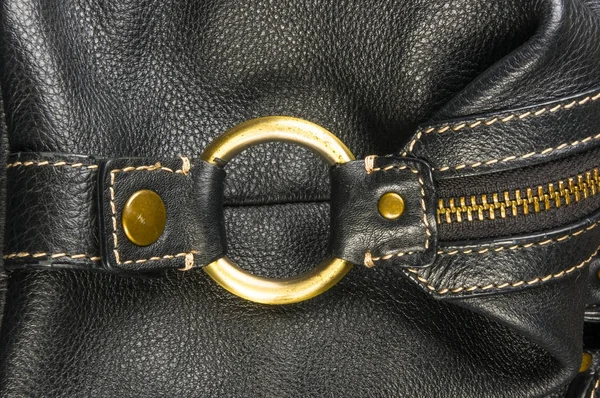 seams on leather hand bag