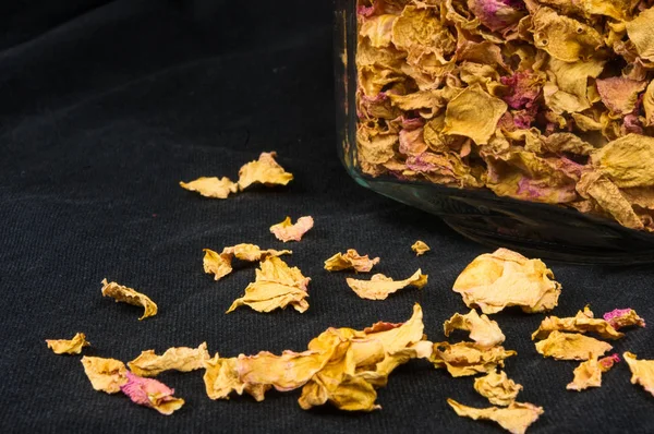 dried rose petals in a glass jar with lid