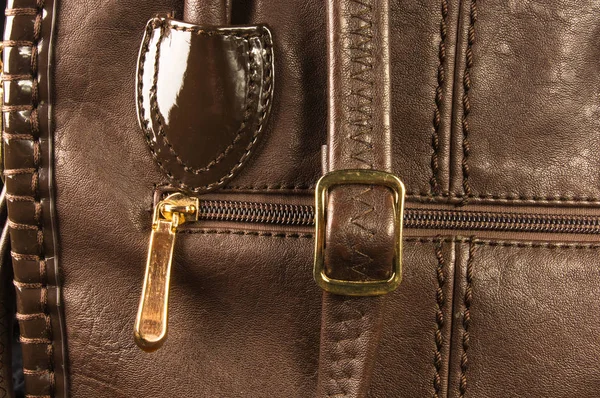 seams on leather hand bag