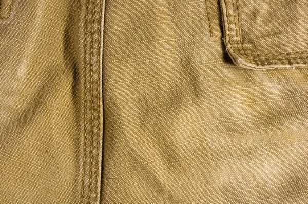clothing items washed cotton fabric texture with seams, clasps, buttons and rivets, macro, close-up