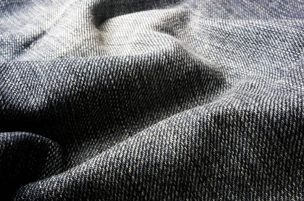 clothing items blue washed faded jeans cotton fabric texture with seams, clasps, buttons and rivets, macro