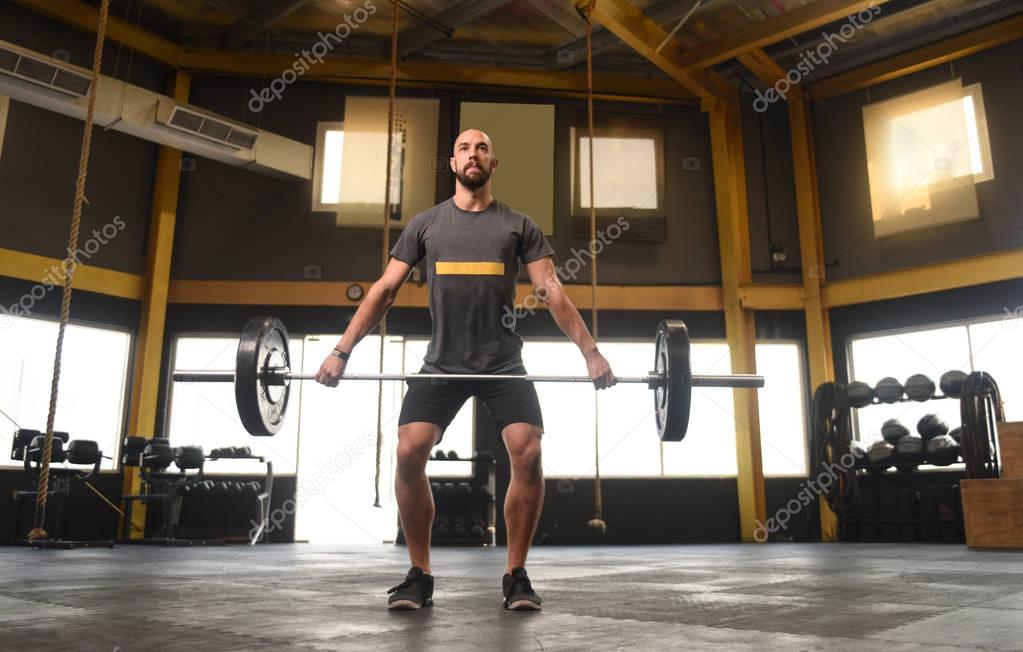 Strong man doing a crossfit power lift