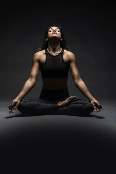 Beautiful Indian woman sitting crossed legged  yoga pose — Stock Photo, Image