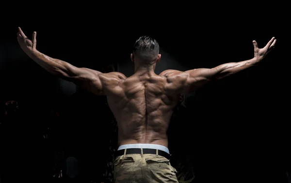 Bodybuilder showing muscular back — Stock Photo, Image