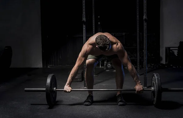 Muscular White Caucasian man about to pick up a barbell — Stock Photo, Image