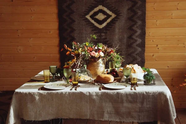 Fall holiday table decoration setting on wooden table. Rustic style