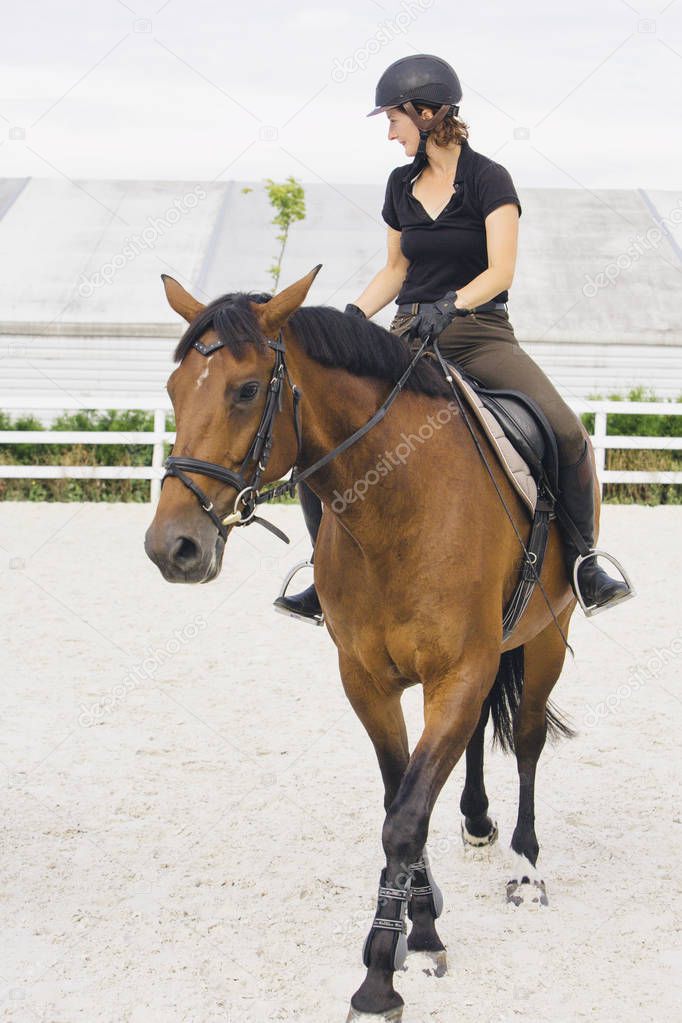 Woman Riding a Horse in Jumper Ring
