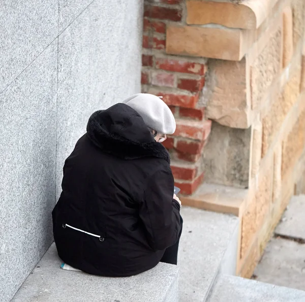 Lonely woman sitting on the stairs — Stock Photo, Image