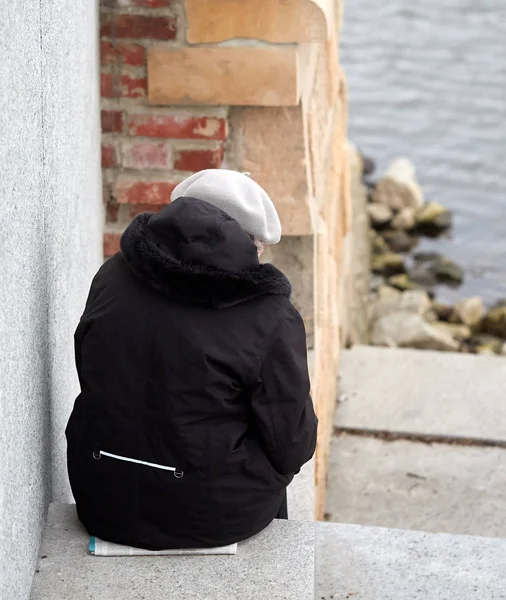 Lonely woman sitting on the stairs — Stock Photo, Image