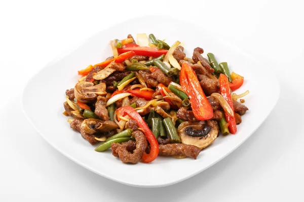 Meat in Chinese, pork, Chinese sauce, mushrooms, green beans, bell pepper — Stock Photo, Image