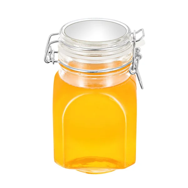 Dulce miel en frasco de vidrio, sobre fondo blanco — Foto de Stock