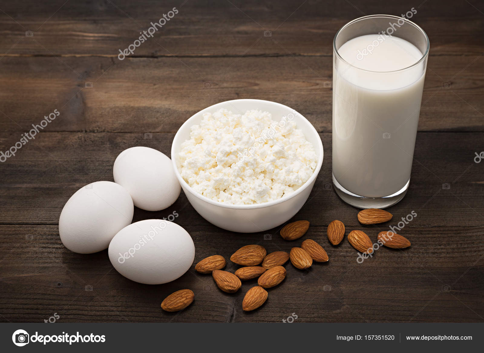 Dairy products on wooden table. Cottage cheese, milk, egg. Top view