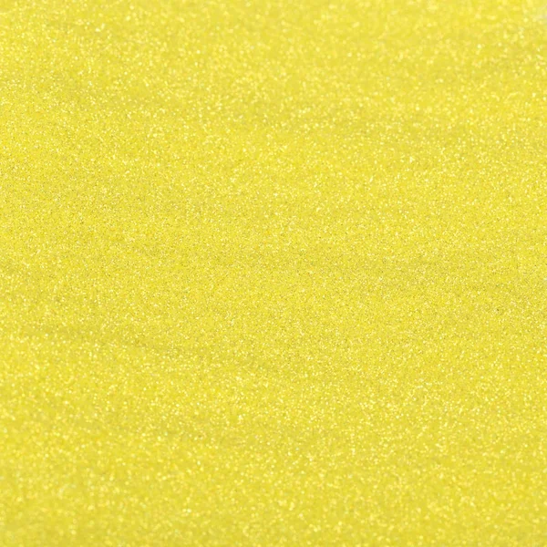 Goldglänzende Textur, gelbe Pailletten mit unscharfem Hintergrund — Stockfoto