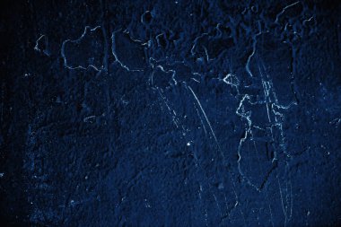 Vintage blue background. Rough painted wall of sapphire color. Imperfect plane of blue colored. Uneven old decorative toned backdrop of cyan tint. 