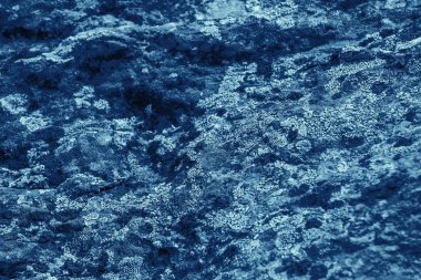 Vintage blue background. Rough painted wall of sapphire color. Imperfect plane of blue colored. Uneven old decorative toned backdrop of cyan tint. 