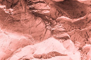 Vintage pink background. Rough painted wall of living coral color. Imperfect plane of beige colored. Uneven old decorative toned backdrop of beige tint.