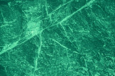 Vintage green background. Rough painted wall of emerald color. Imperfect plane of virid colored. Uneven old decorative toned backdrop of green tint. 