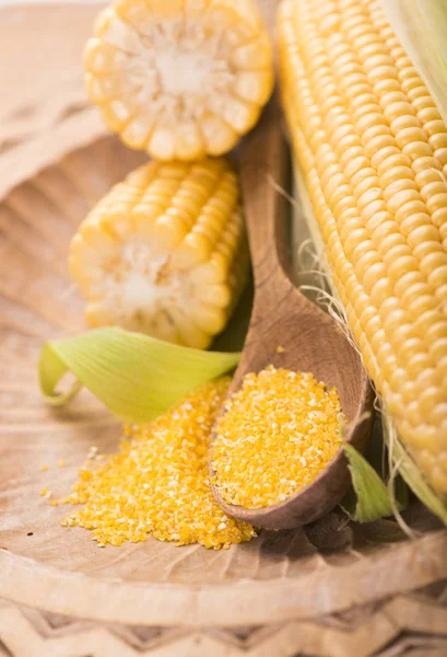 Flour corn in a spoon on the dark wooden boards — Stock Photo, Image
