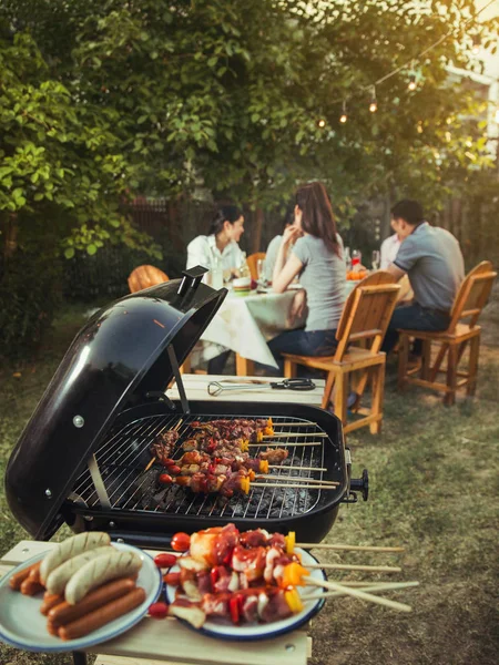 Dinner party, barbecue and roast pork at night — Stock Photo, Image