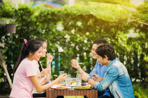 Asian ethnicity Having breakfast in the garden at home. Everyone