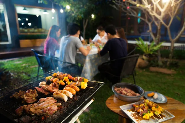 Dinner party, barbecue and roast pork at night — Stock Photo, Image
