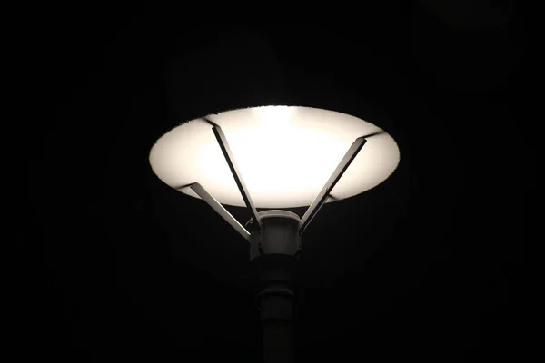 Lampadaire lumineux sur fond noir — Photo
