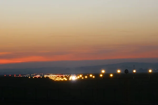 Flight security lights and landing strip in sunsed  bakground