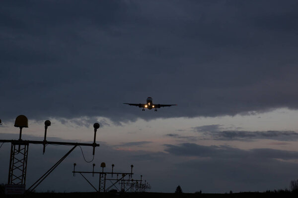 The plane lands at dusk