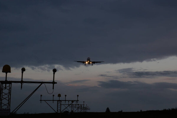 The plane lands at dusk