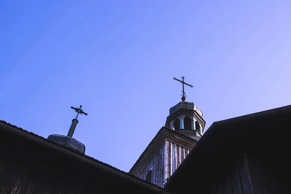 Old wooden Church with the crosses on the domes against the blue — Stock Photo, Image