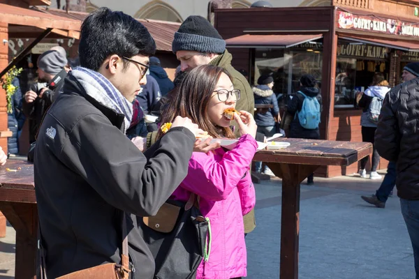 KRAKOW, POLONIA, 2 de abril de 2018, Joven asiático y chica comiendo s — Foto de Stock