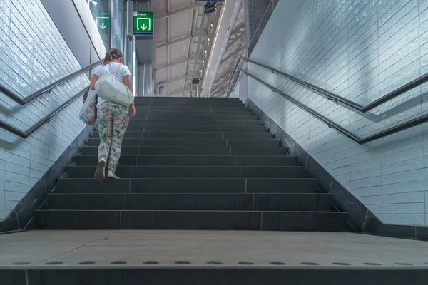 Amsterdam / Holland - 9/12/14-Girl climbing subway stairs — Stock Photo, Image