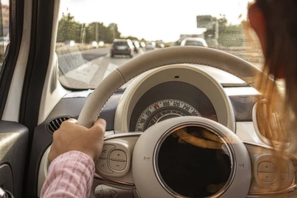 Girl driving with a view of the freeway