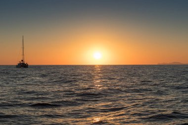 Güzel gün batımı denizden gördün. Bir katamaran ile Santorini