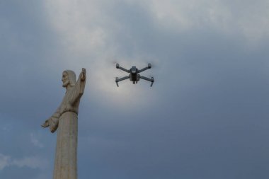 Famous Lubango landmark. King Christ. with a drone flying. clipart