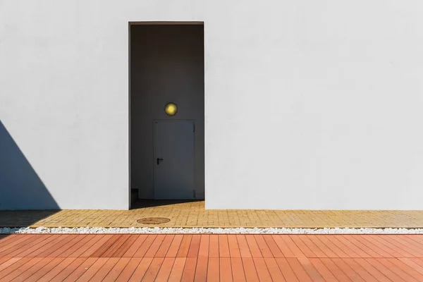 Minimalist door with white wall and red floor. — Stock Photo, Image