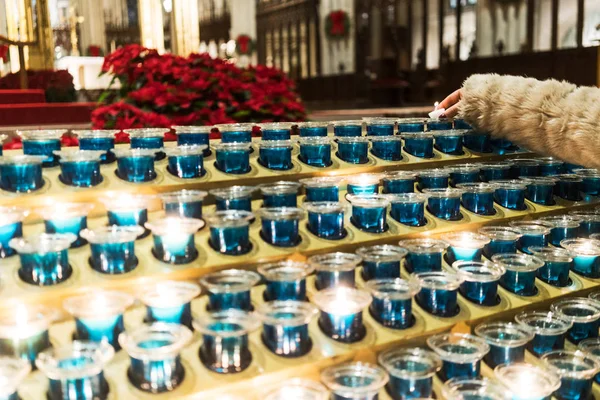 Woman's hand lighting candles in church. New York. — Stock Photo, Image