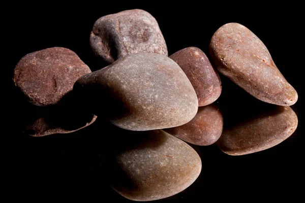 Ore from a diamond mine. isolated on black background with reflexion.