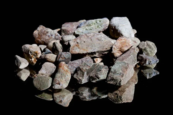 Ore from a diamond mine. isolated on black background with reflexion. — Stock Photo, Image