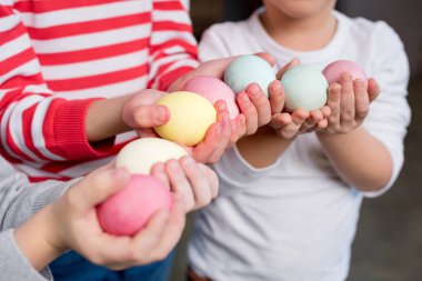 Paskalya yumurtaları tutan çocuklar