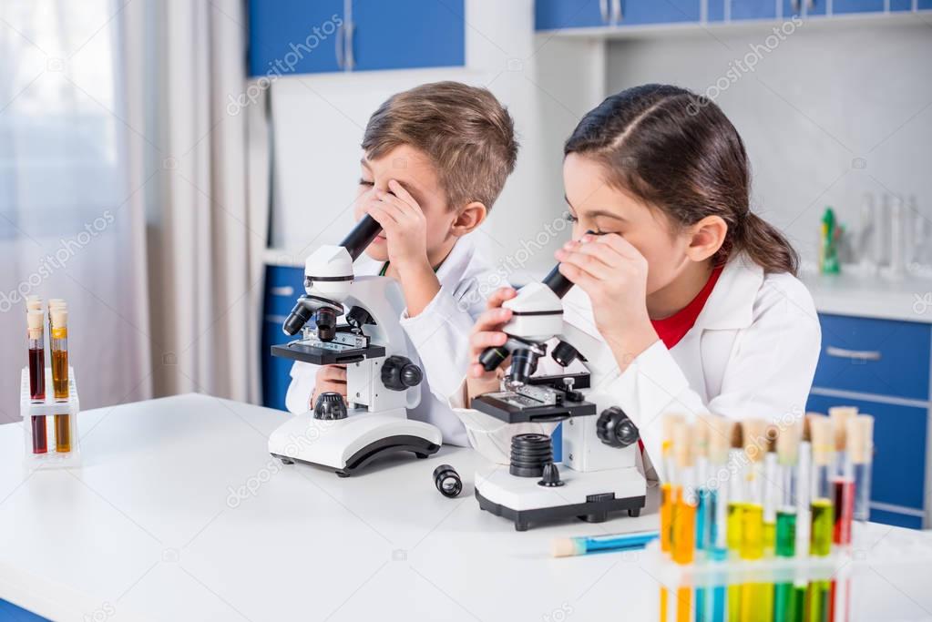 Kids using microscopes