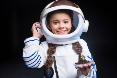 Girl astronaut holding plant clipart