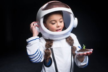 Girl astronaut holding plant clipart
