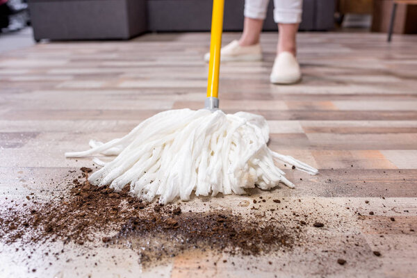 Woman cleaning floor with mop