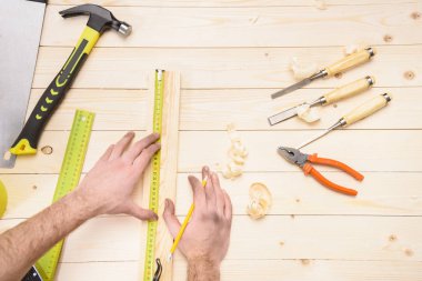 carpenter measuring plank clipart