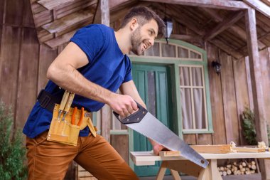 carpenter sawing wood clipart