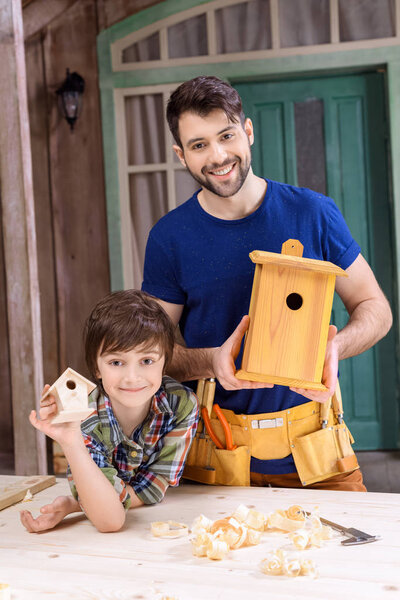 Father and son making birdhouses 