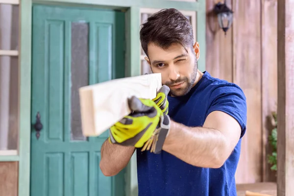 Carpenter working with wooden plank — Stock Photo, Image